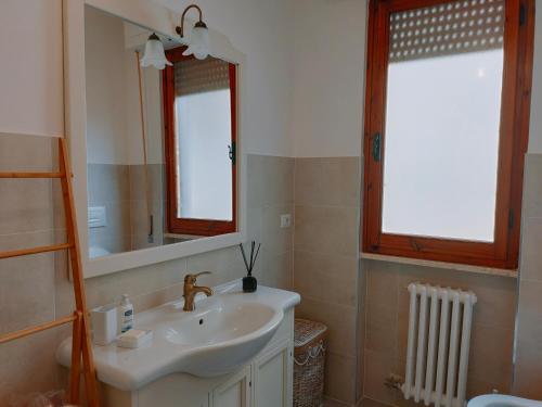 a bathroom with a sink and a mirror at Casa ANNA in Montevarchi