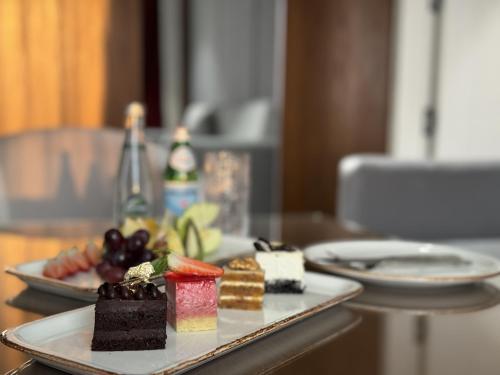 two plates of desserts sitting on a table at Ankawa Holiday Hotel in Erbil