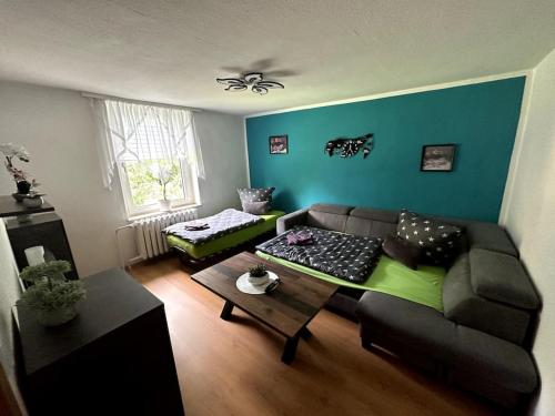 a living room with a couch and a table at Ferienwohnung Monteurwohnung Apartment Wettin-Löbejün in Gottgau