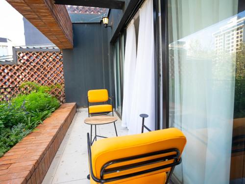 two yellow chairs are sitting on a balcony at Zarafa Suites in Nairobi