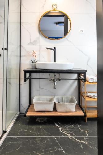 a bathroom with a sink and a mirror at Island Apartments in Izola