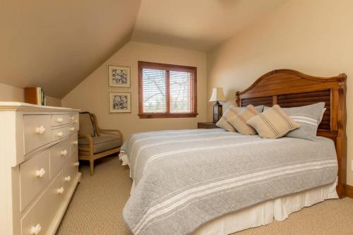 a bedroom with a large bed and a dresser at Endless Summers Fabulous Lake oasis in Port Severn
