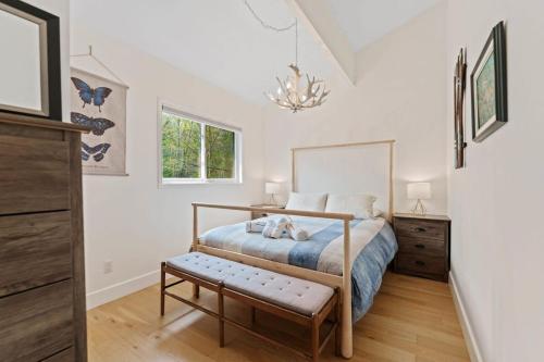 a bedroom with a bed and a chandelier at Muskokan Mirage Located on Mirage Lake in Novar