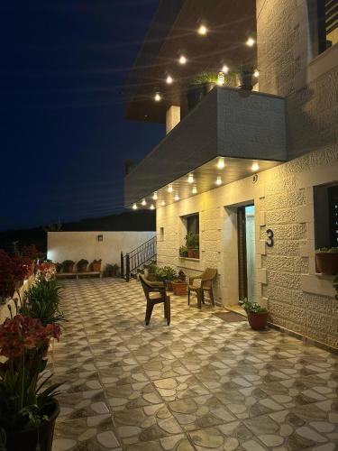 a building with a patio at night with lights at Jerash City View in Jerash