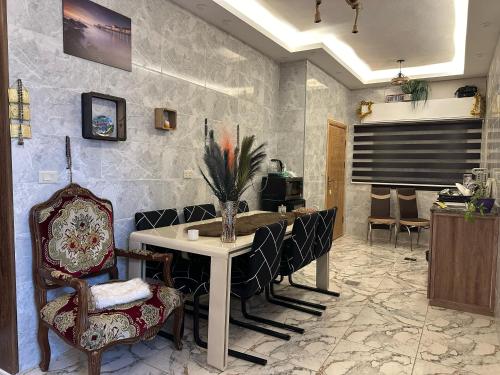 a dining room with a table and chairs at Jerash City View in Jerash