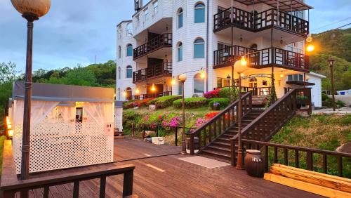 a building with a staircase leading up to a building at Travely Hotel Gapyeong in Gapyeong