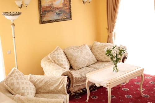 a living room with a couch and a table at СПА-Готель "RESPECT" in Skhidnitsa