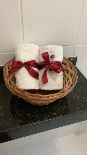 a basket of towels with bows on a counter at Pousada Mar dos Sonhos in Paripueira