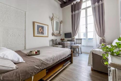 a bedroom with a bed and a living room at La Belle Du Marais in Paris