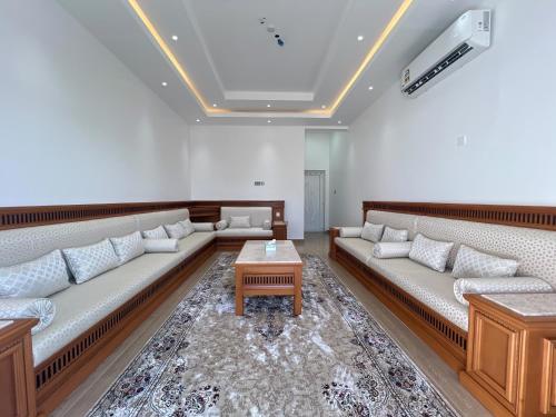 a living room with couches and a coffee table at ALSALAM HOSTELS in Nizwa