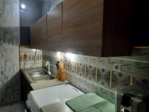 a small kitchen with a sink and a counter at chateau angele w&b in Lomé
