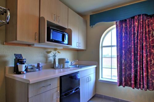 a kitchen with a sink and a window at Key West Inn - Tunica Resort in Tunica Resorts