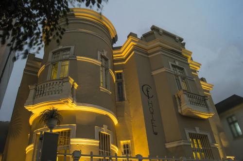 a large yellow building with lights on it at Casa Falleri Boutique Hotel in Lima