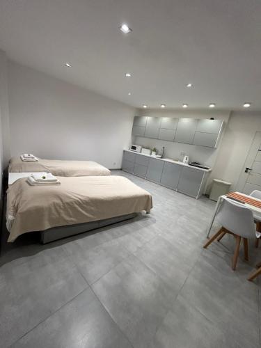 a bedroom with a large bed and a table at Pod Chmielową Szyszką in Chmielnik