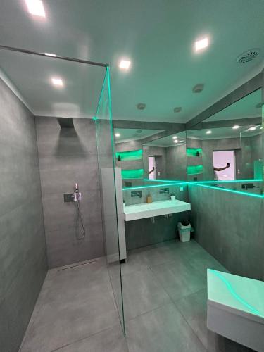 a bathroom with a glass shower and a sink at Pod Chmielową Szyszką in Chmielnik