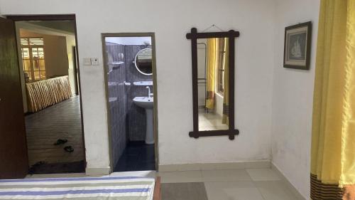 a bathroom with a mirror and a sink at Henas Revrstone Holiday in in Matale