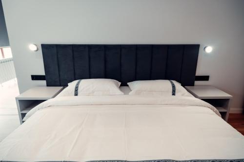 a large white bed with two white pillows at Green Hill in Almaty
