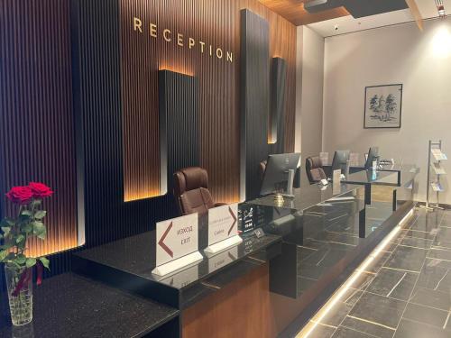 a hair salon with a reception desk and chairs at Hotel & Casino Cherno More in Varna City