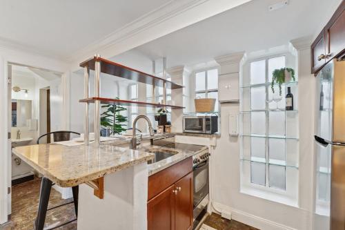 a kitchen with a sink and a counter at Unique & Charming 2 Bedroom One Block to King St in Charleston