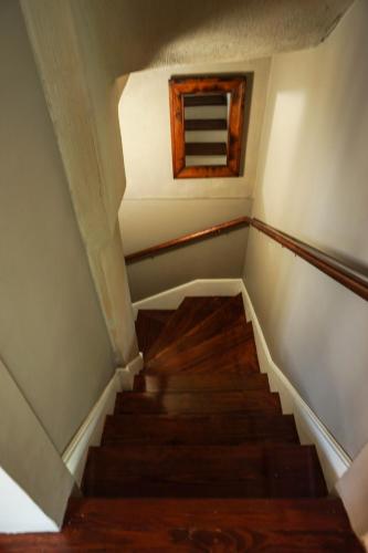 a staircase in a house with a window at The Most Charming Old Brick Alley Charleston in Charleston