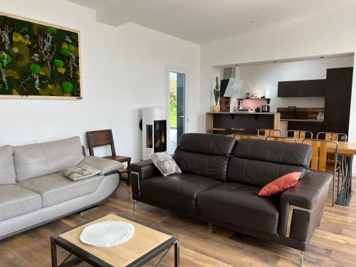 a living room with a couch and a table at Le Gwern in Pleumeur-Bodou