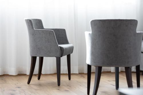 two chairs sitting next to each other in a room at Waldhotel Arosa in Arosa