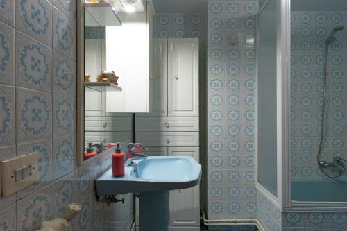 a bathroom with a blue sink and a mirror at El clavelar del Sablón in Llanes