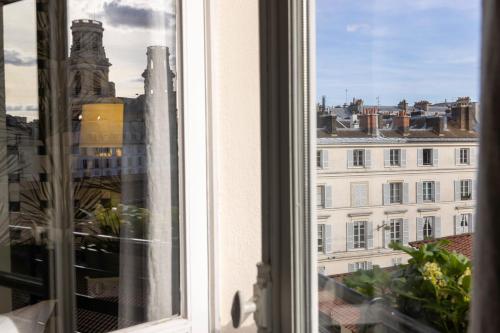 a window with a view of a city at Hotel Clément in Paris