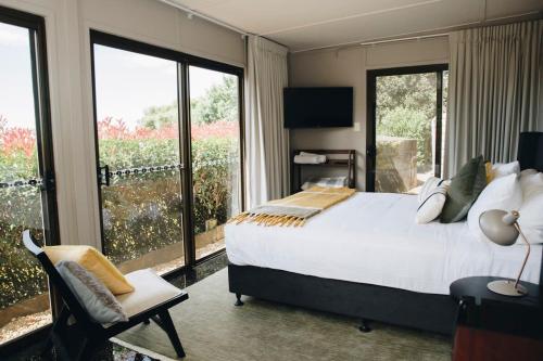 um quarto com uma cama grande e uma varanda em Flaxton residence with spectacular coastal views em Montville