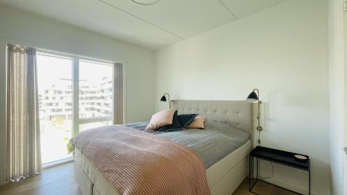 a bedroom with a bed with a large window at ApartmentInCopenhagen Apartment 1566 in Copenhagen