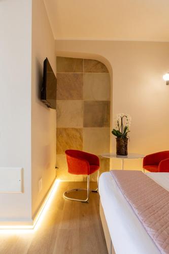 a bedroom with a bed and a table and chairs at Villa Battibecco in Loreto