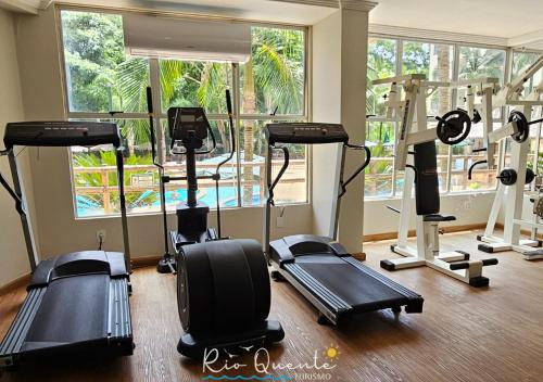 a gym with treadmills and elliptical machines at Thermas Paradise Residence in Rio Quente