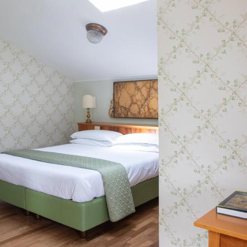 a bedroom with a large bed and a table at Villa Battibecco in Loreto