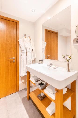 a bathroom with a sink and a mirror at The Athens Gate Hotel in Athens