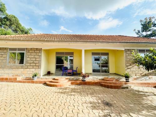 a house with a patio in front of it at Dangotte Residence Lounge in Kabale