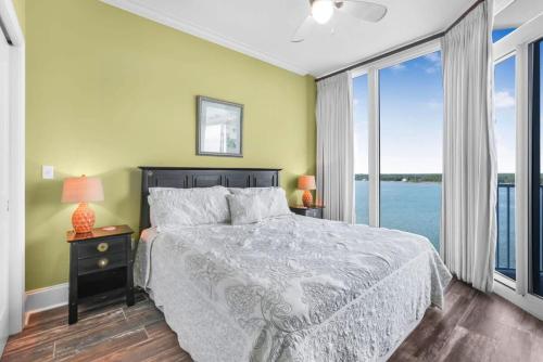 a bedroom with a bed with a view of the water at Bel Sole 1102 Spacious water view beach access in Gulf Shores