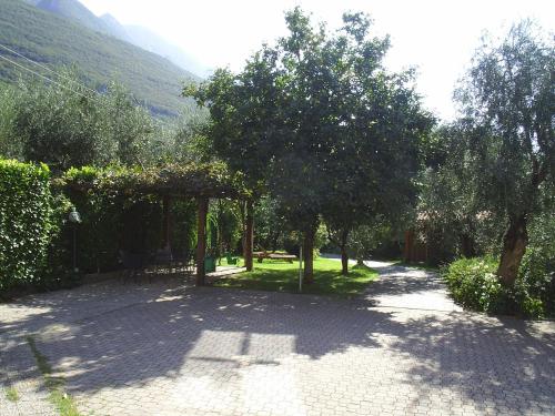 a garden with a pavilion and trees on a path at Casa Antonelli in Malcesine
