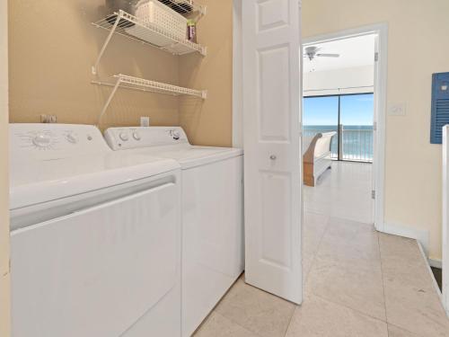 a white laundry room with a washer and dryer at Seagrove Dunes #1 in Seagrove Beach