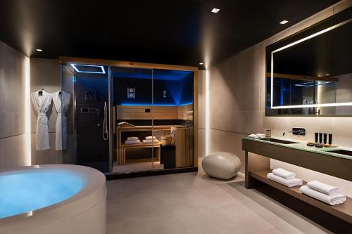 a bathroom with a tub and a sink at The Pantheon Iconic Rome Hotel, Autograph Collection in Rome