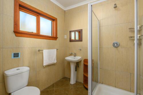 a bathroom with a toilet and a sink and a shower at Sugar Beach Resort in Elysium