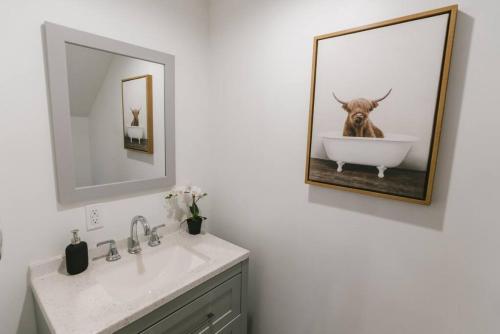a bathroom with a picture of a bull in a bath tub at Beautiful, Spacious Apartment, Near DTLA in East Los Angeles