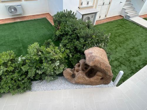 an aerial view of a garden with a statue at Aqualife luxury home 4 in Arzachena