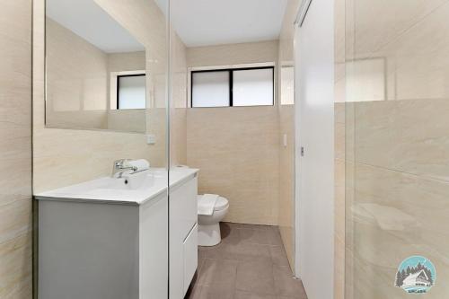 a bathroom with a white sink and a toilet at Aircabin - Kingswood - Sydney - 3 Beds Townhouse in Kingswood