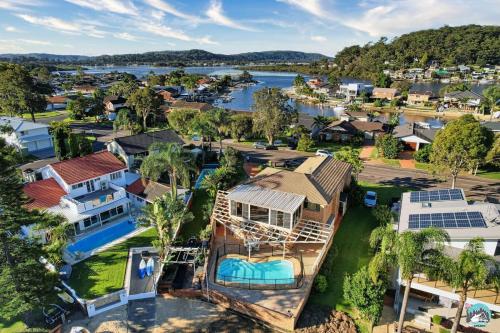 an aerial view of a house with a lake at Aircabin - Woy Woy - Water Front - 6 Beds Lux Home in Daleys Point