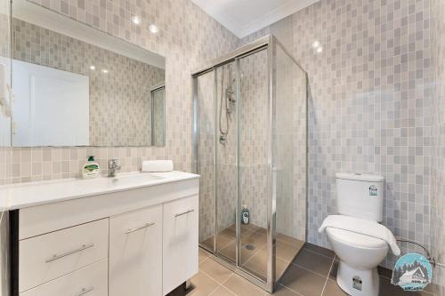 a bathroom with a shower and a toilet and a sink at Aircabin - Panania - Sydney - Cozy - 5 Beds House in Panania