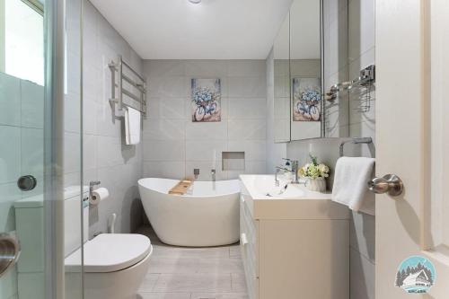 Un baño con bañera, inodoro y lavabo. en Aircabin - Seven Hills - Lovely - 3 Beds Townhouse, en Blacktown