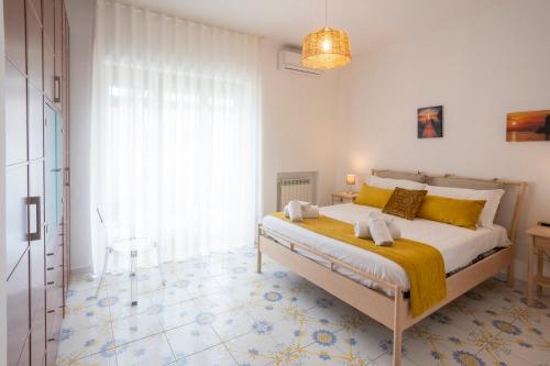 a bedroom with a large bed with yellow pillows at Casa Patty Sorrento in Sorrento