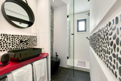 a bathroom with a sink and a mirror at MichELe Luxury apartments by Smaris Collection in Malia