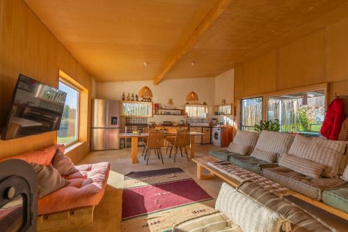 a living room with couches and a dining room at Casa CORTIJO con piscina privada in Tarifa