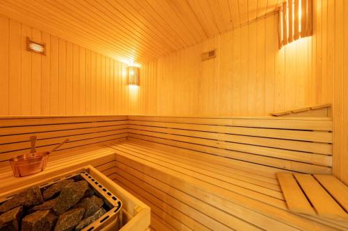 an empty wooden sauna with a tub in it at Thalassa Beach Resort 1 Bedroom with a partial Sea View and Courtyard View in Vokolidha